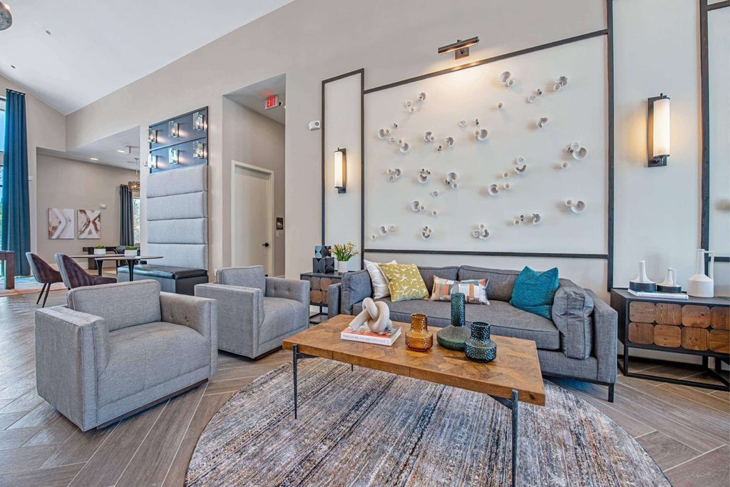 a living room with a couch and chairs and a table