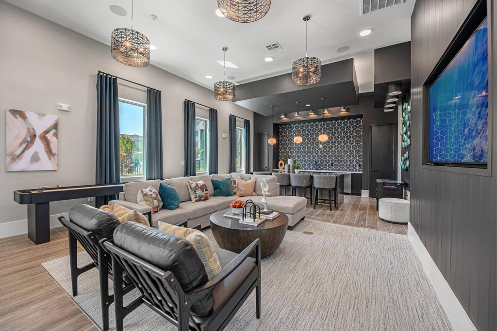 a living room with couches and chairs and a bar