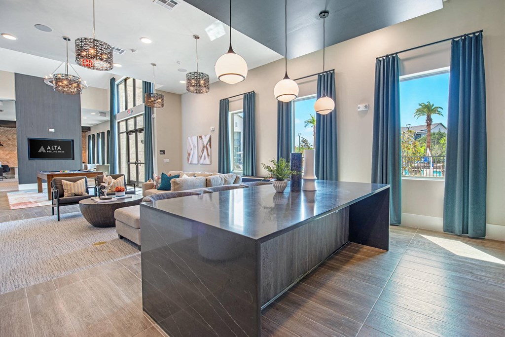 a large living room with a large table and windows