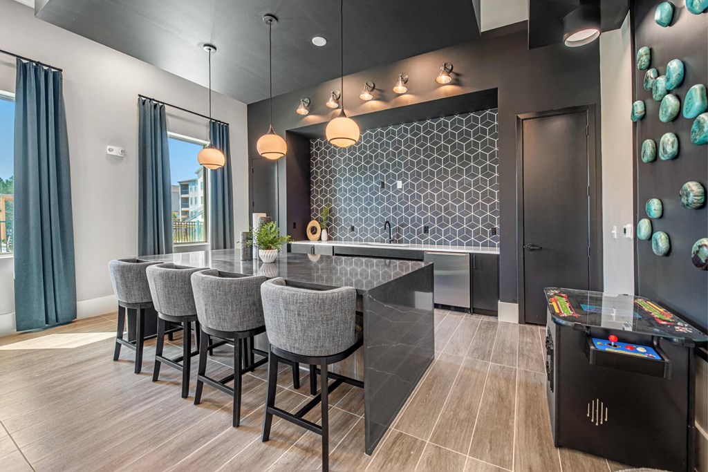 a kitchen with a large island and a bar with chairs