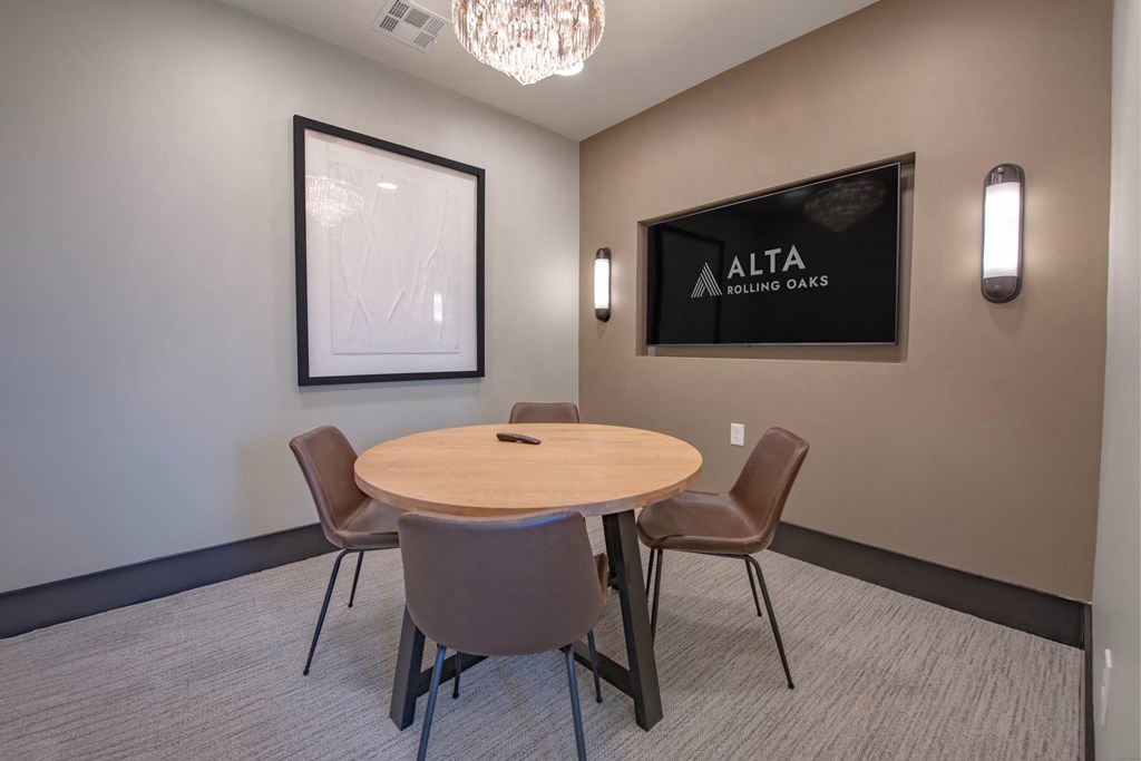 a conference room with a round table and chairs