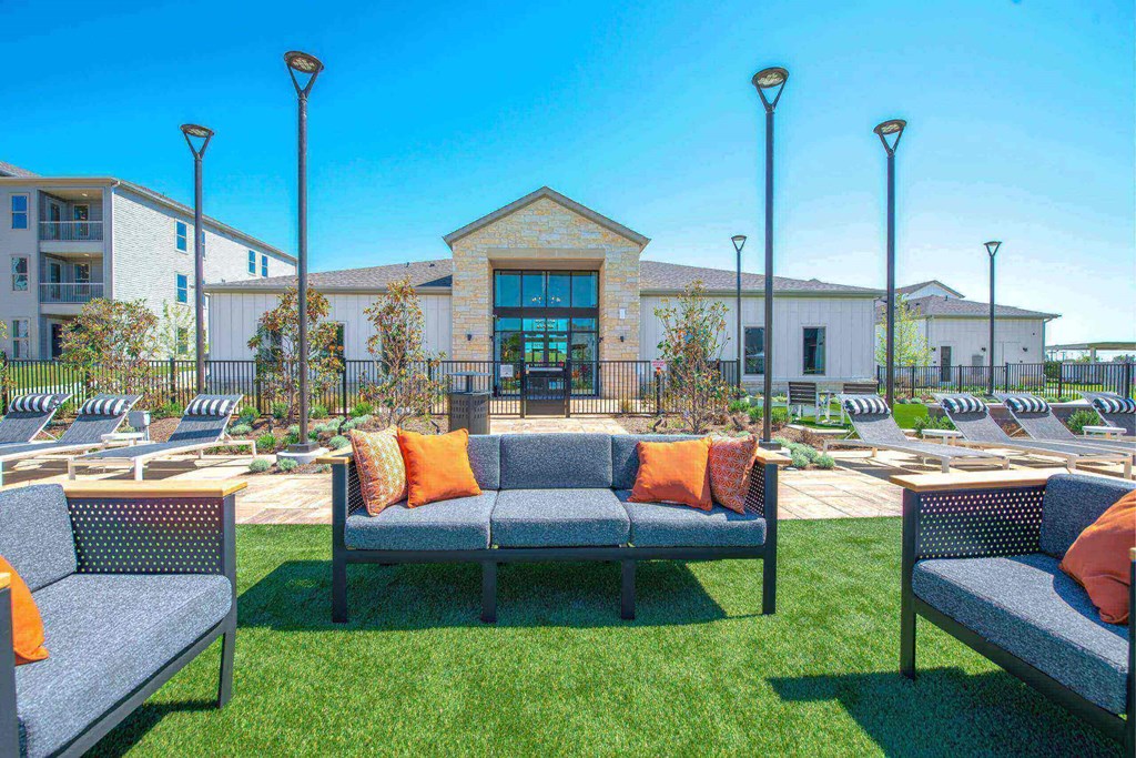 a lounge area with couches and chairs outside of a building