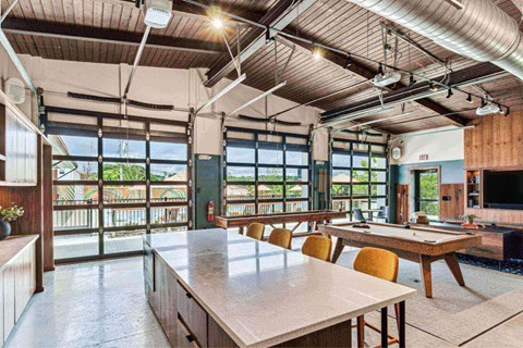 a large room with a pool table and a table