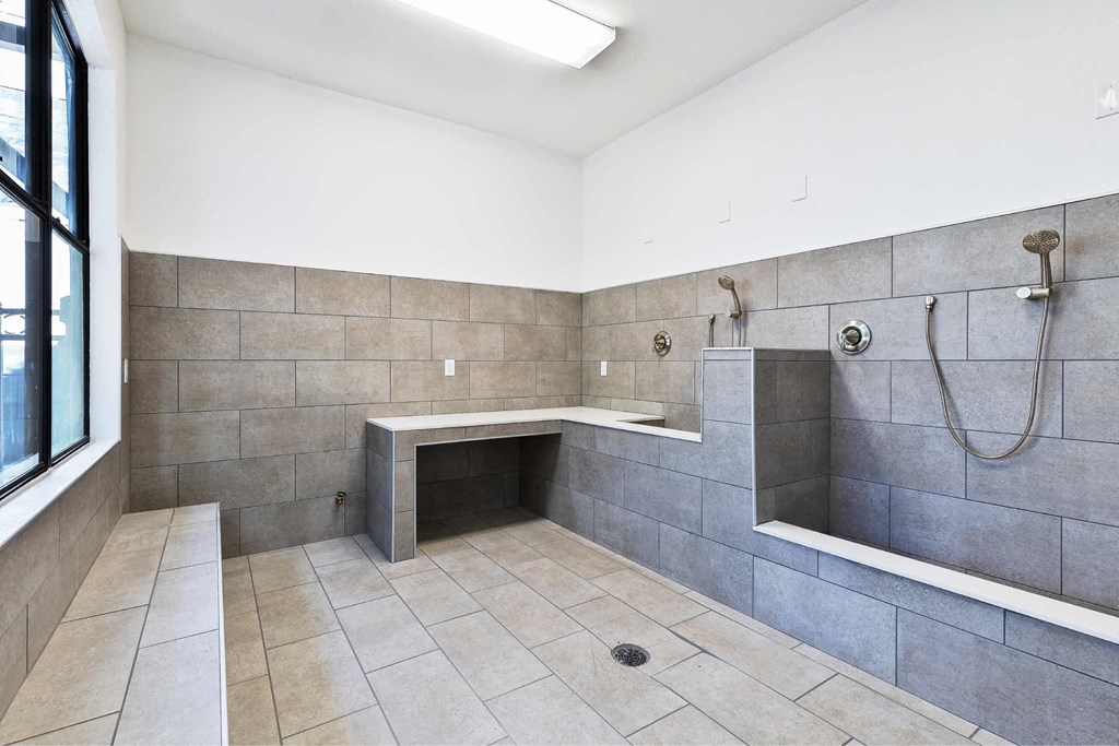 a large bathroom with a shower and a sink