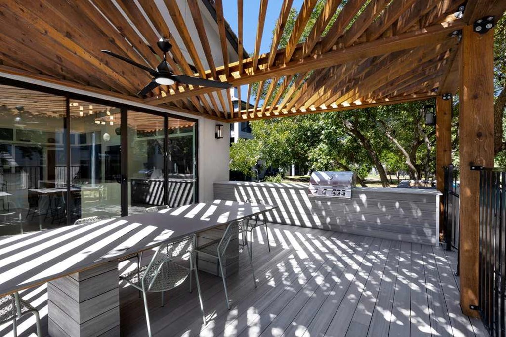 a covered patio with a table and chairs