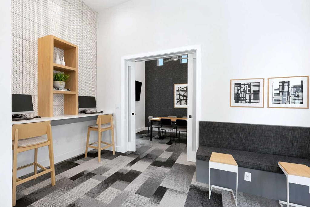 a seating area in a room with a desk and a door