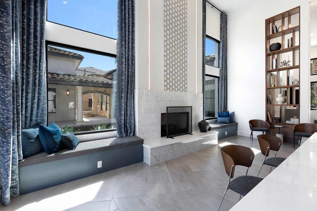 a living room with a fireplace and a large window