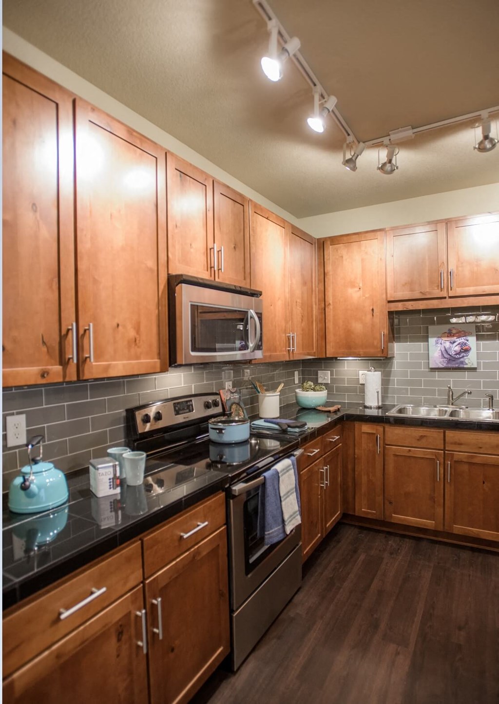 a kitchen with wooden cabinets and stainless steel appliances