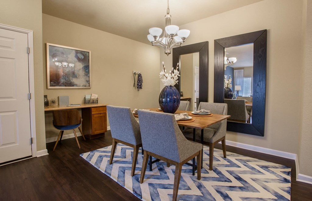 a dining room with a table and chairs