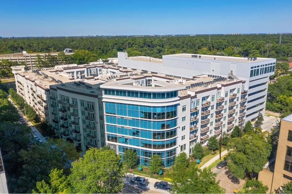 an aerial view of a large building surrounded by trees