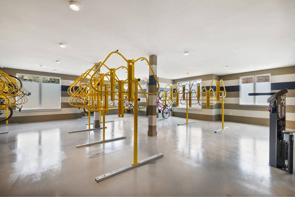 the gym at the building has a large amount of yellow equipment