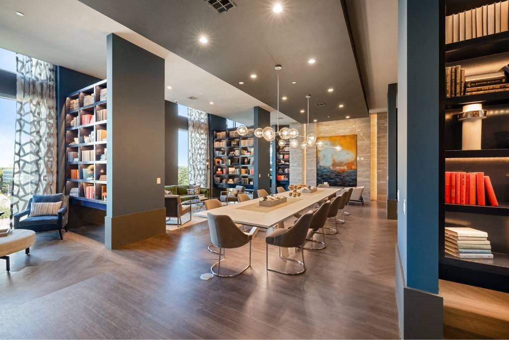 a dining room with a long table and chairs in a library