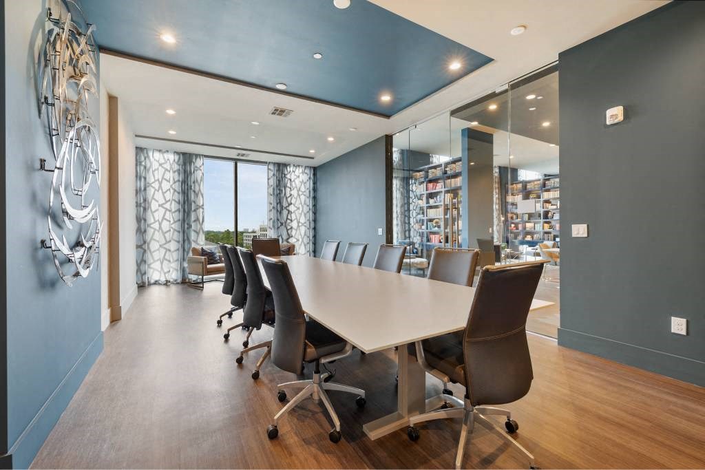 a conference room with a long table and chairs
