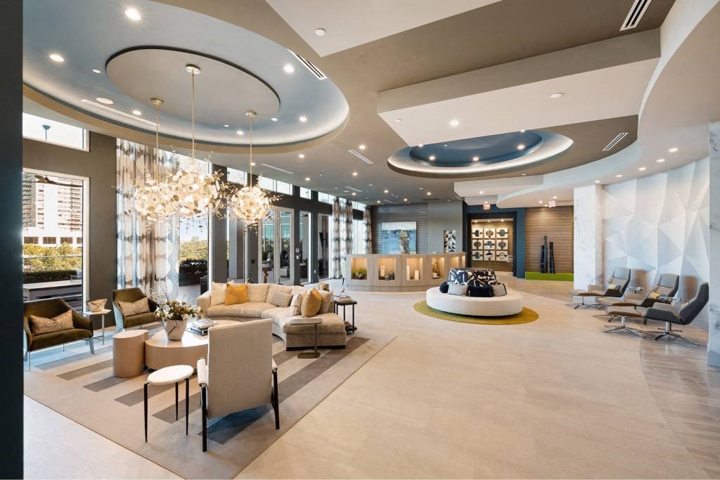 a large lobby with couches and chairs and a table