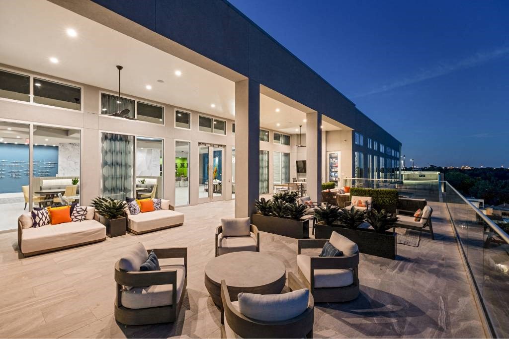 a spacious living room with furniture and a patio