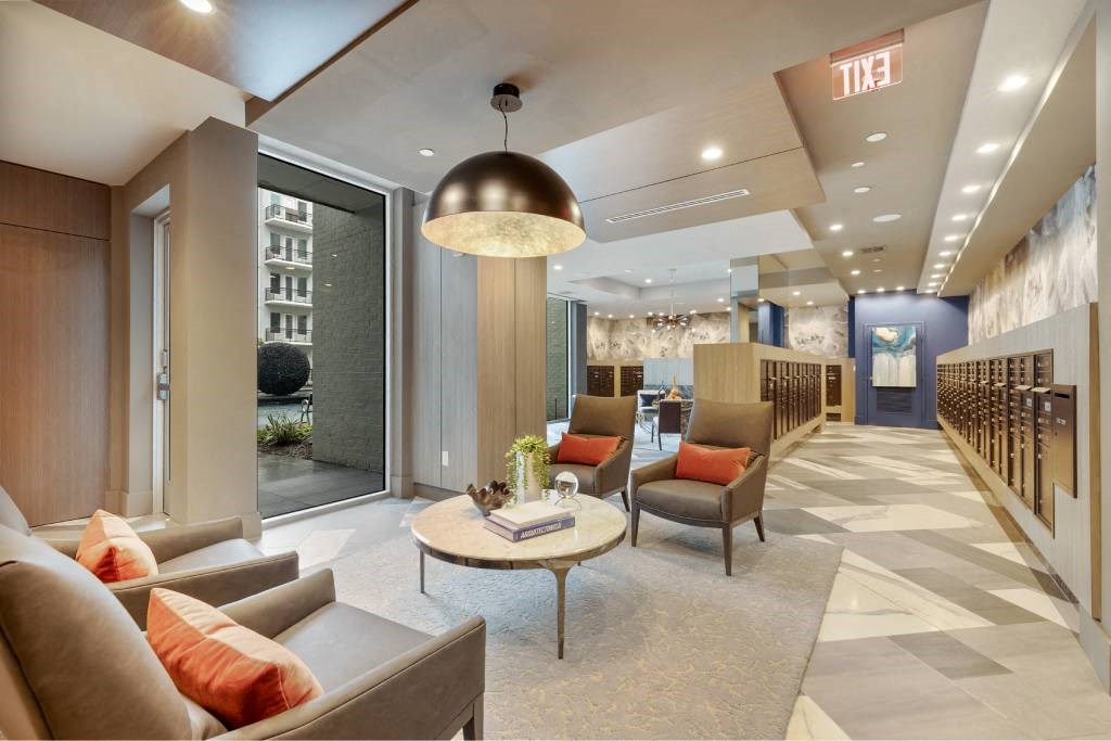 a lobby of a hotel with couches and chairs