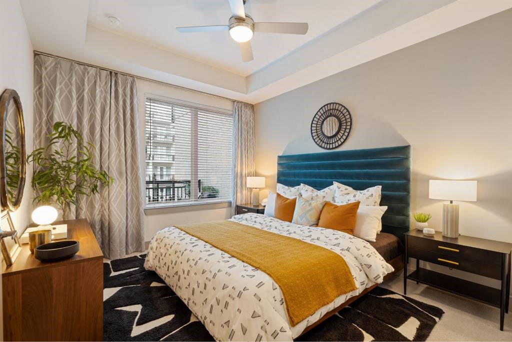 a bedroom with a bed and a blue headboard