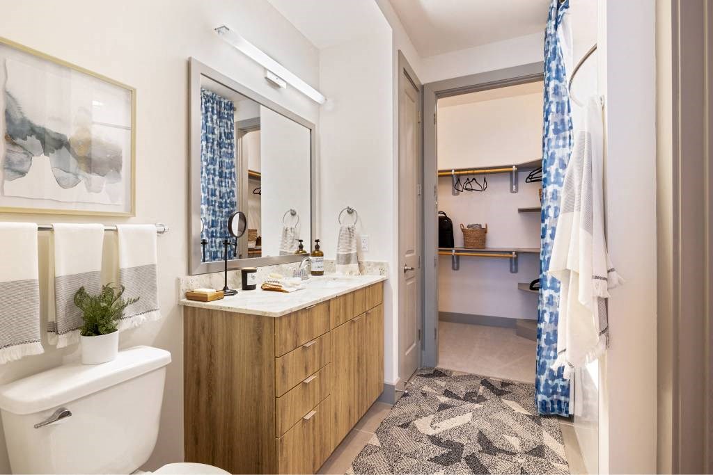 a bathroom with a toilet and a sink and a shower