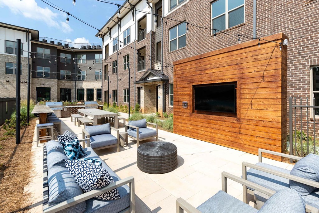 an outdoor patio with furniture and a tv