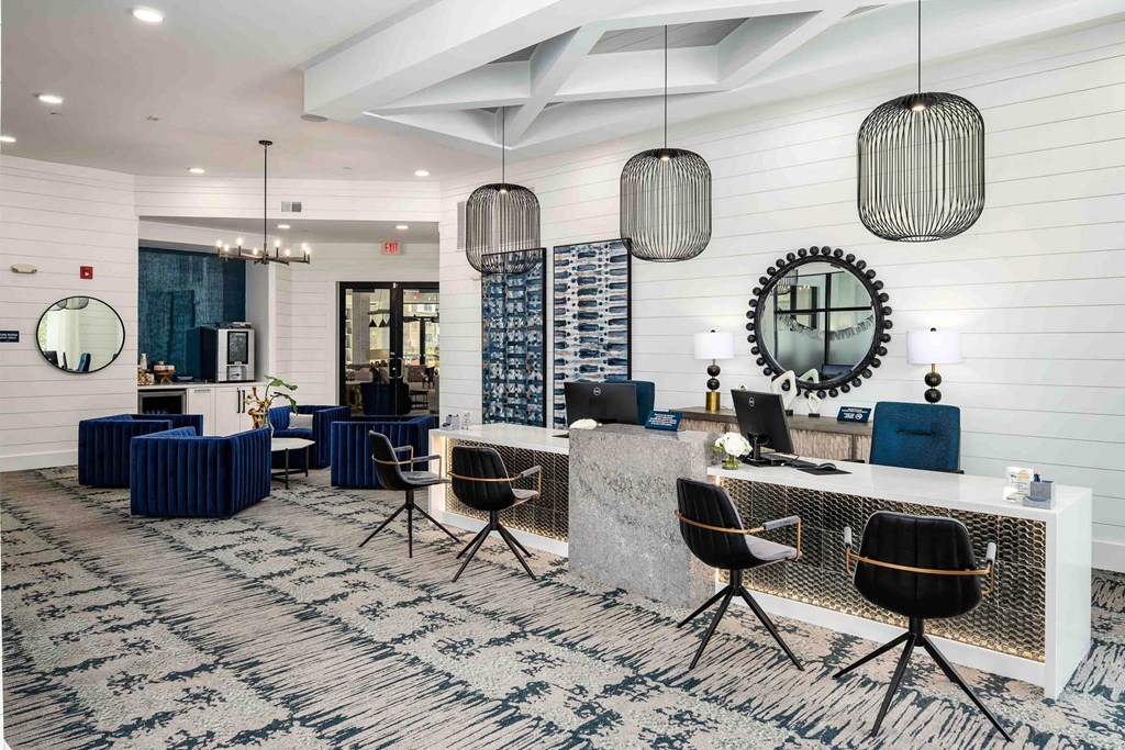 a large lobby with a reception desk and chairs