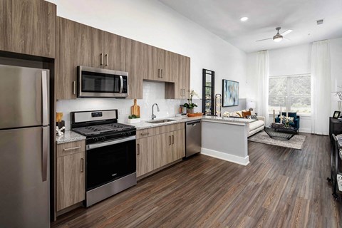 A modern kitchen with wooden cabinets and stainless steel appliances.