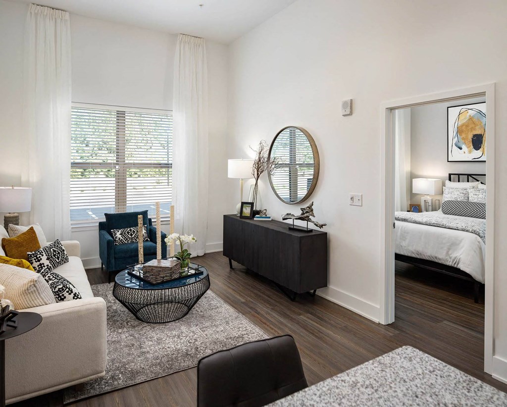 A modern living room with a blue chair and a coffee table.