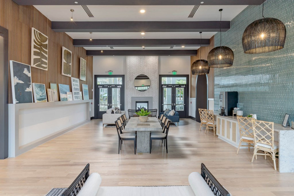 a large living room with a table and chairs and a fireplace