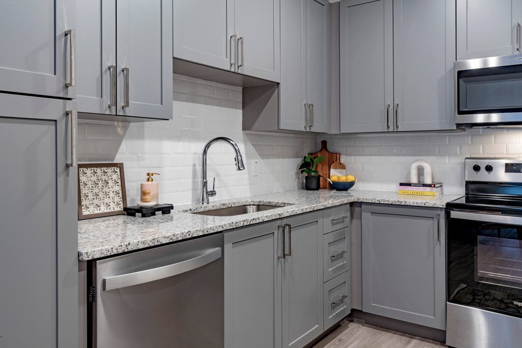 kitchen with white cabinets and granite counter tops and stainless steel appliances