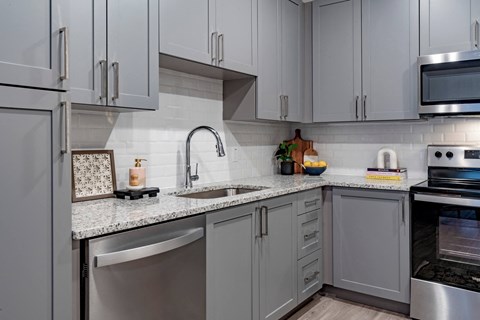 kitchen with white cabinets and granite counter tops and stainless steel appliances