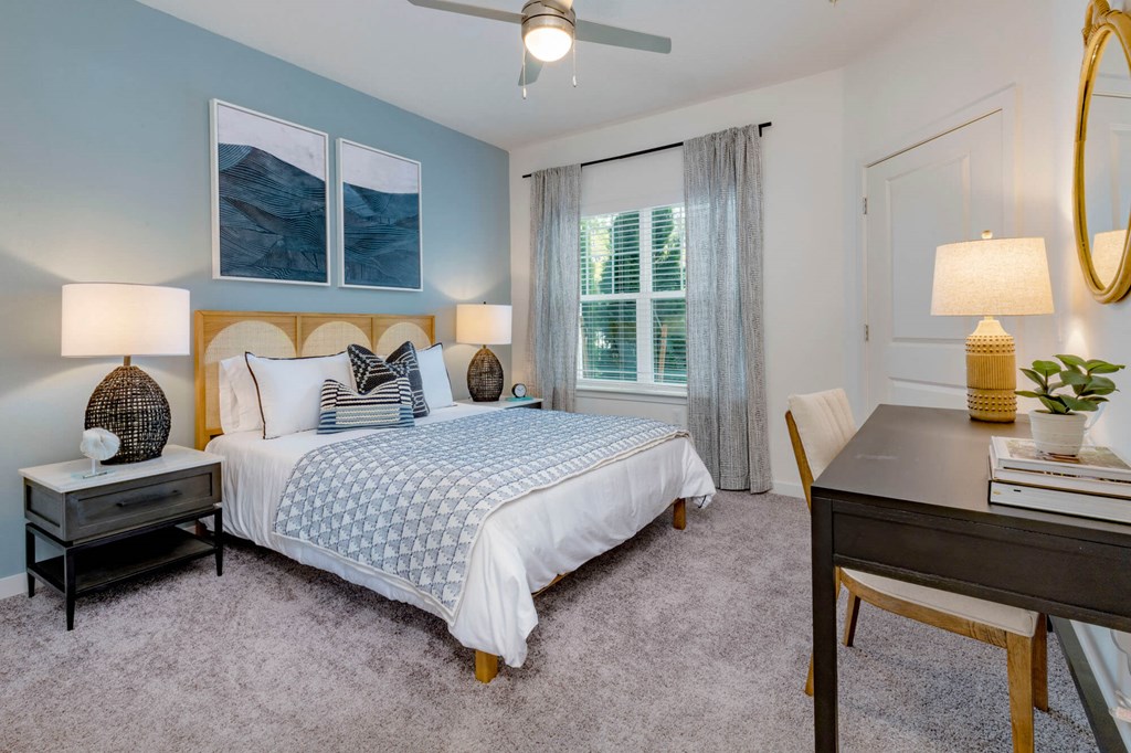 a bedroom with a bed and a desk