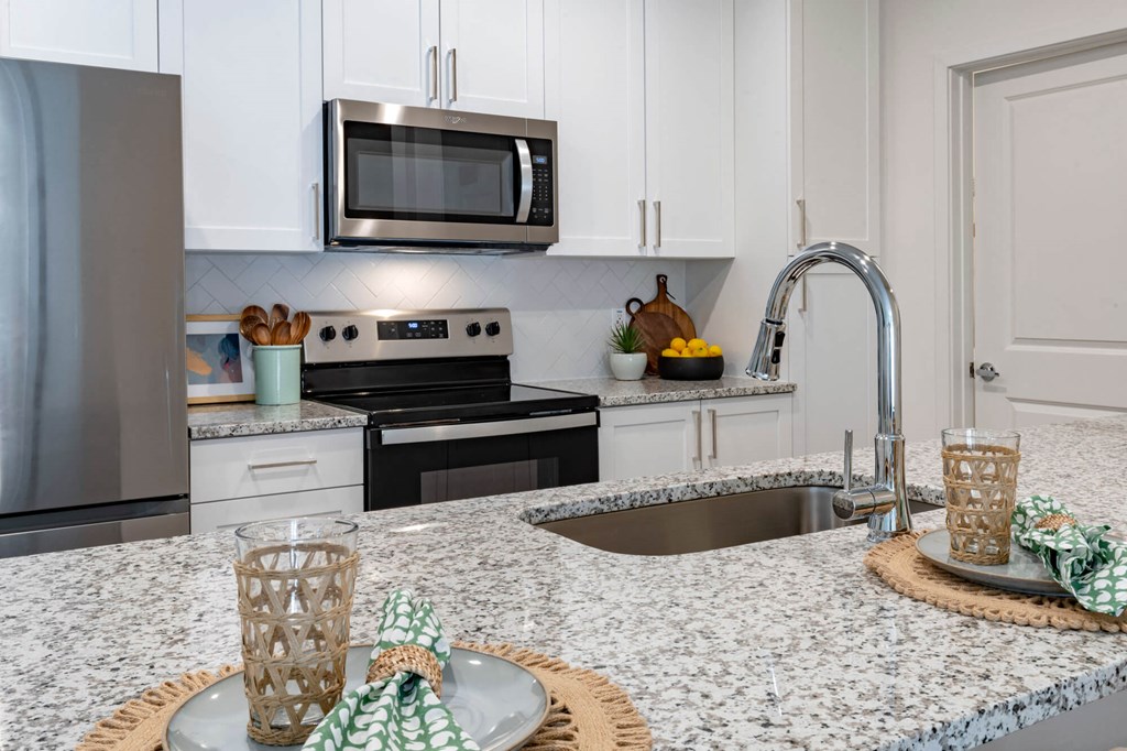 a kitchen with granite counter tops and stainless steel appliances