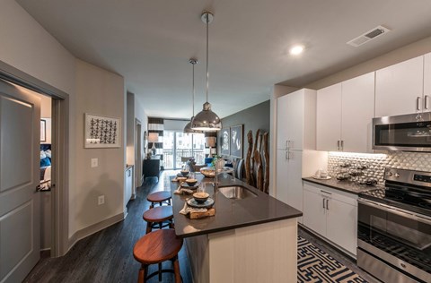 A kitchen with a bar stool and a counter.