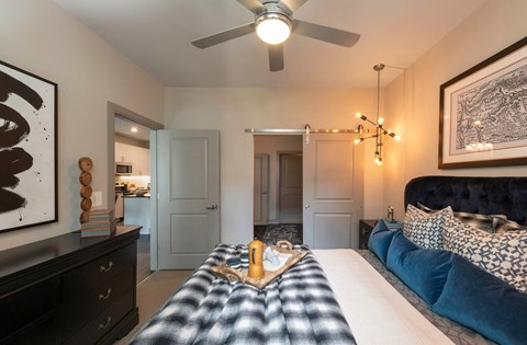 a bedroom with a bed and a ceiling fan