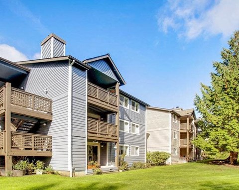 a row of houses with balconies and a green lawn at Vista Ridge, Washington, 98027