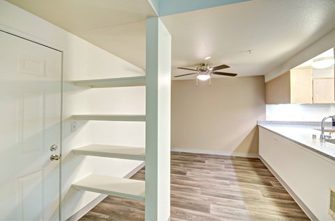 a kitchen with white cabinets and a ceiling fan at Vista Ridge, Washington, 98027