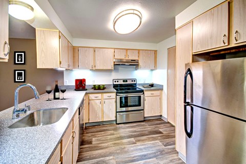 a kitchen with stainless steel appliances and wooden cabinets at Vista Ridge, Issaquah, WA, 98027
