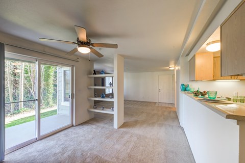 a kitchen and living room with a ceiling fan and a window at Vista Ridge, Issaquah, WA