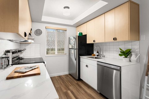 a kitchen with a white counter top and a stainless steel refrigerator at Scout, Kirkland, Washington