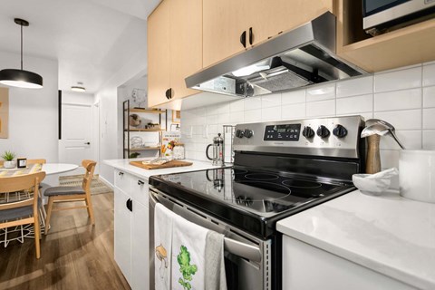 a kitchen with a stove top oven and a sink at Scout, Kirkland, Washington