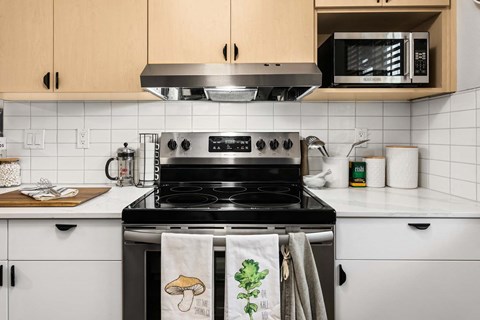 a kitchen with a stove and a microwave at Scout, Kirkland, WA