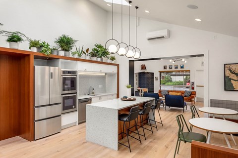 a kitchen with a large island and a table with chairs at Scout, Washington, 98034