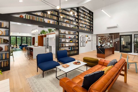 a living room filled with furniture and a library at Scout, Kirkland, 98034