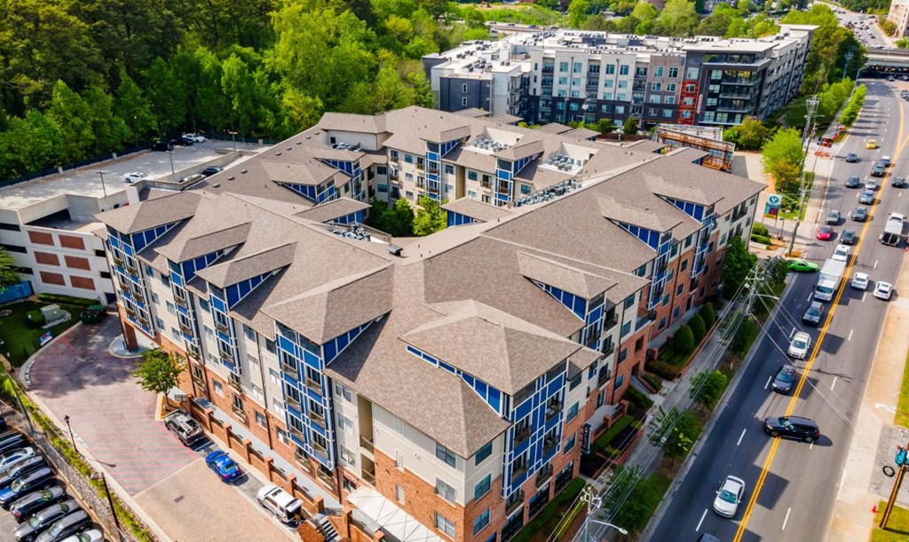 a view of a building from above with cars parked in front of it