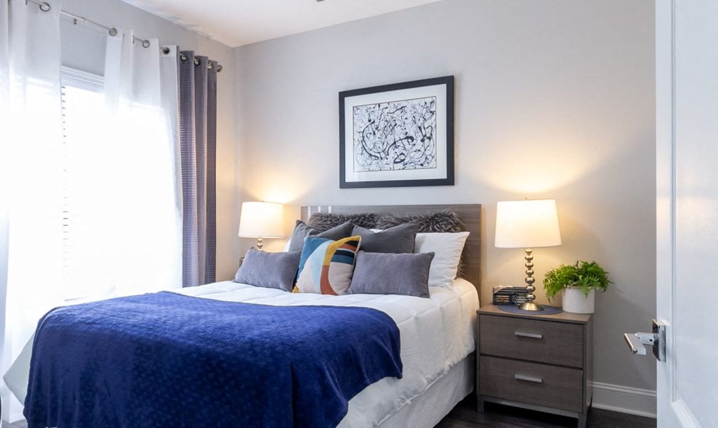 a bedroom with a bed and a window