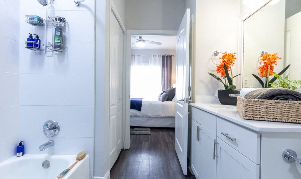 a bathroom with a shower and a sink and a mirror