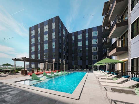 a large swimming pool with lounge chairs in front of a building