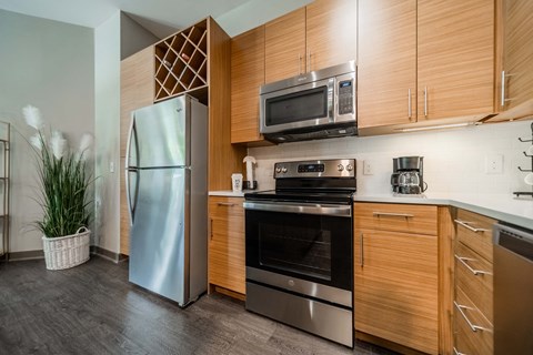 a kitchen with stainless steel appliances and wooden cabinets