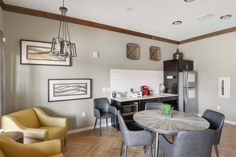 a dining room and kitchen with a table and chairs