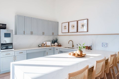 a kitchen with a white counter top and blue cabinets