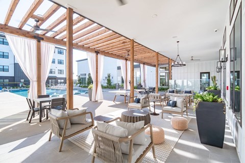 a communal area with chairs and tables and a pool